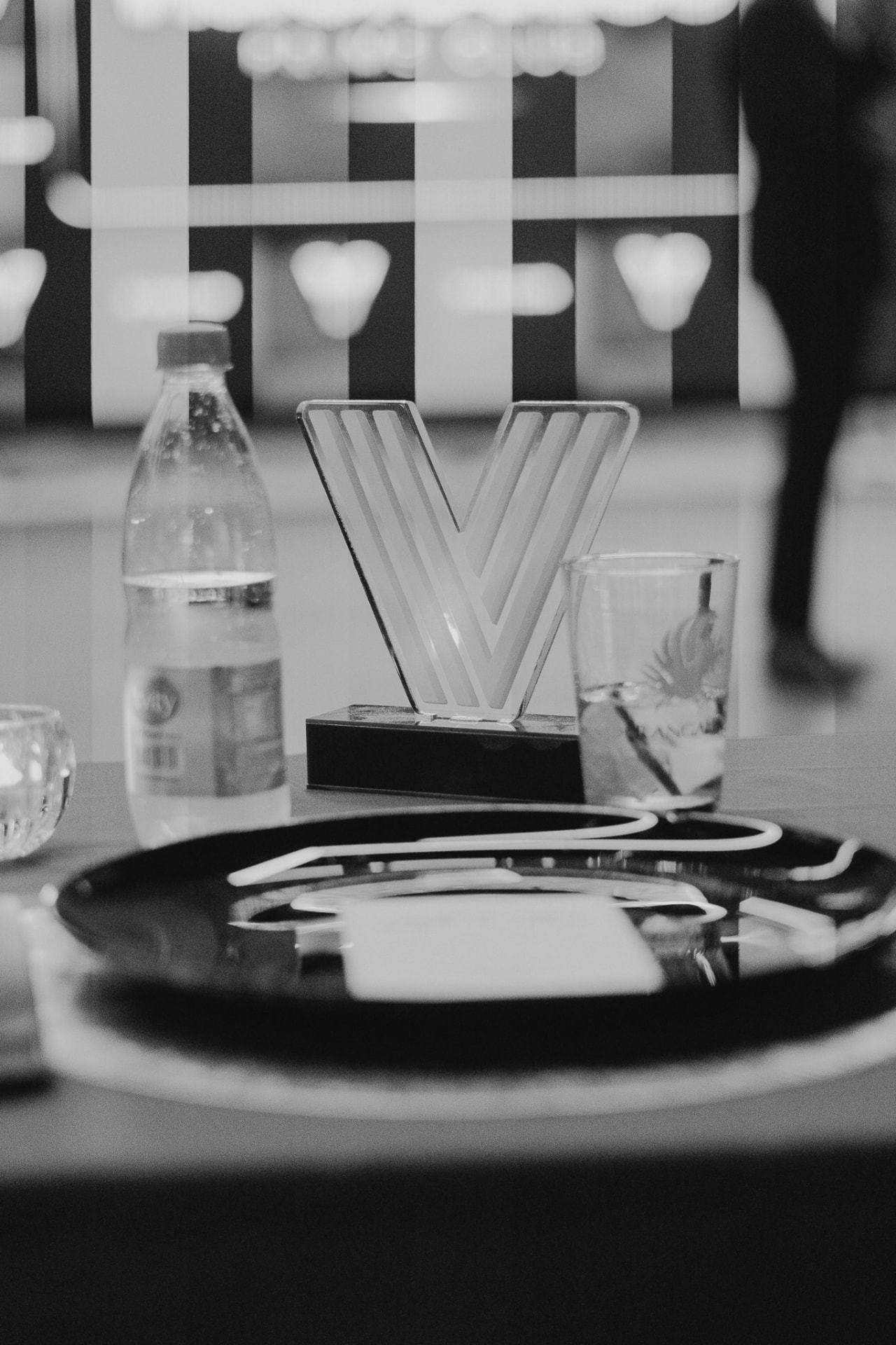 Detalhe de mesa com o V em acrílico e peças de serviço durante um encontro do Prime Club